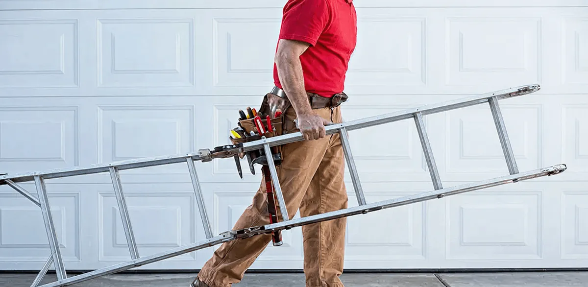 Garage door repair technician arriving with tools and ladder in Cedar Rapids, IA