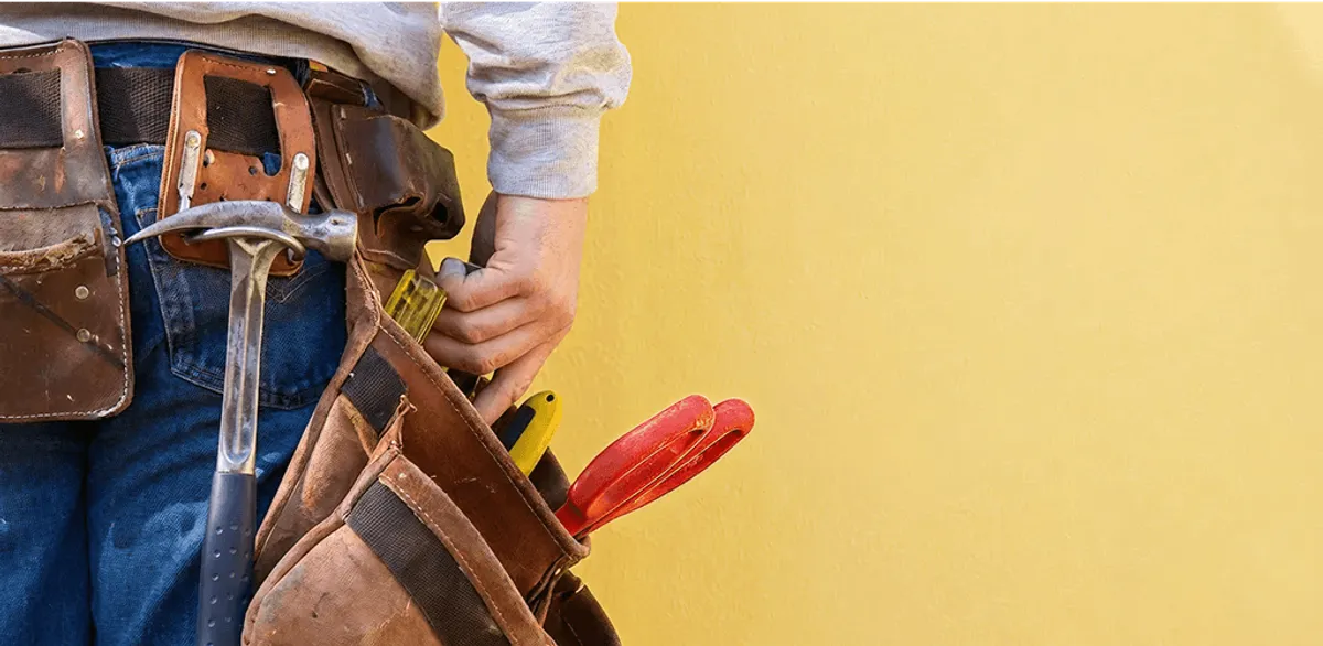 Handyman with tool belt ready for home repairs and maintenance in Cedar Rapids, IA