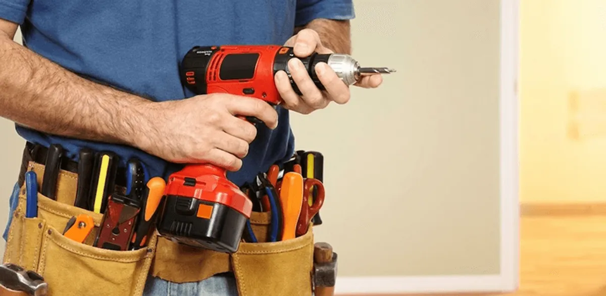 Handyman holding a power drill for home repairs and installations in Cedar Rapids, IA